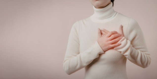 Woman clutching chest from heart issues